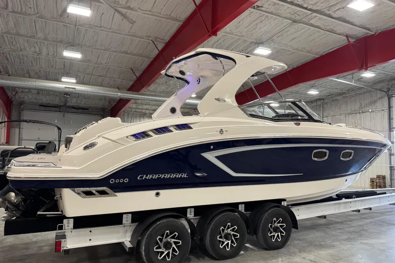 Slide: The Image of 2015 Chaparral 327 SSX boat in indoor storage on a trailer. - 4