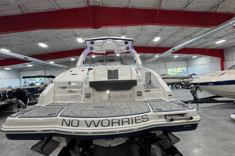 Slide: The Image of 2015 Chaparral 327 SSX boat in showroom, rear view with "No Worries" text. - 5