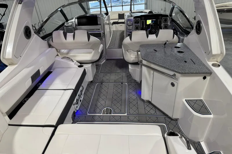 Slide: The Image of 2015 Chaparral 327 SSX boat interior with luxurious seating and modern dashboard. - 7