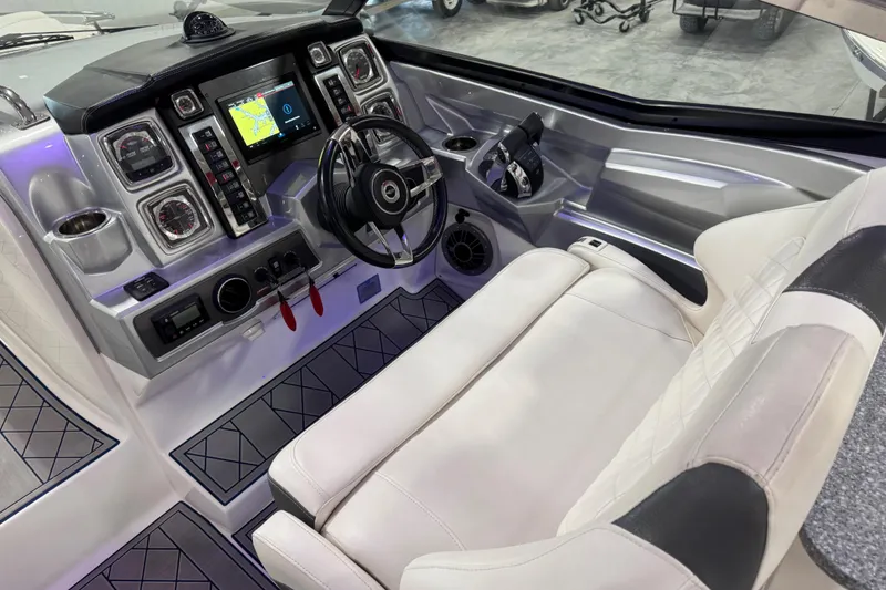 Slide: The Image of Cockpit of 2015 Chaparral 327 SSX boat with modern controls and navigation system. - 9