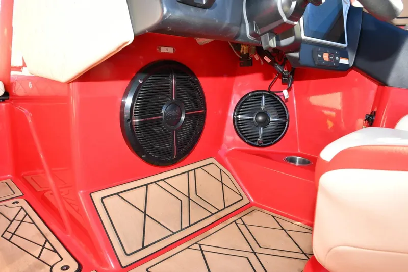 Slide: The Image of 2022 Tigé 24RZX boat interior with red paneling and built-in speakers. - 14