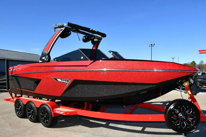 Slide: The Image of 2022 Tigé 24RZX boat in vibrant red on a matching trailer. - 9