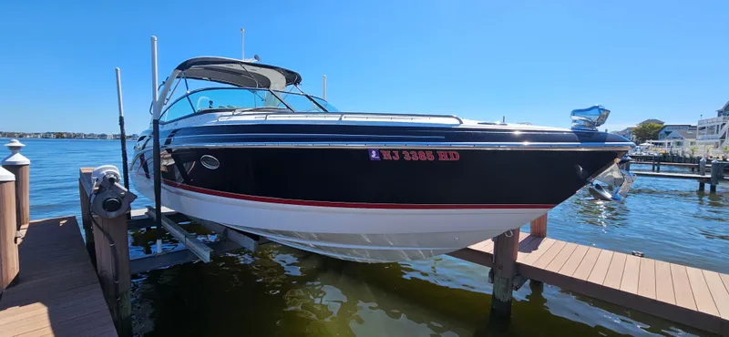 The Image of 2011 Formula 310 Bowrider boat docked on a sunny day, showcasing sleek design and luxury features. - 0