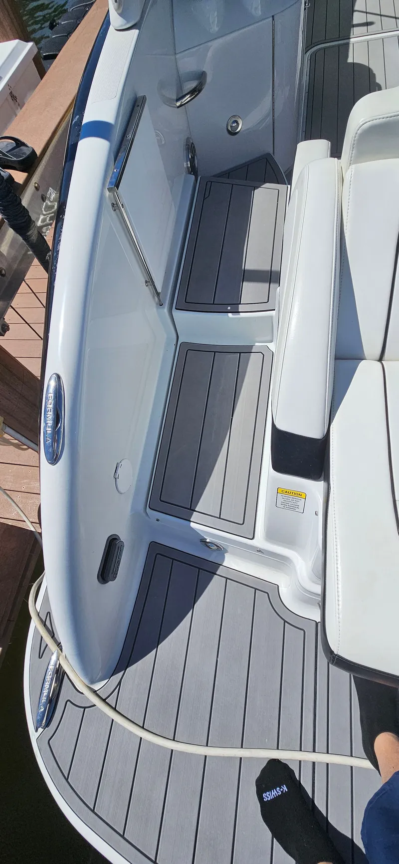 Slide: The Image of 2011 Formula 310 Bowrider boat interior with gray decking and white seating. - 10