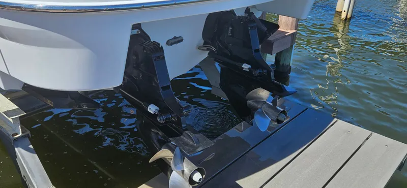 Slide: The Image of 2011 Formula 310 Bowrider boat with dual propellers docked on water. - 15