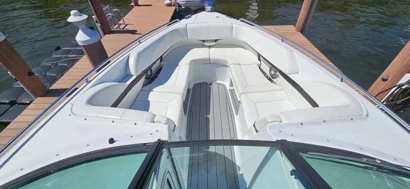 Slide: The Image of 2011 Formula 310 Bowrider with spacious seating, docked on calm water. - 2