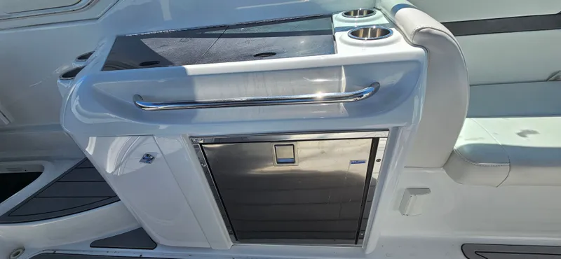 Slide: The Image of 2011 Formula 310 Bowrider interior with sleek kitchenette and stainless steel accents. - 8