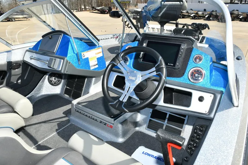 Slide: The Image of 2024 Ranger 212LS Reata boat interior with steering wheel and dashboard controls. - 1