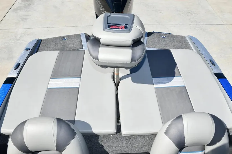 Slide: The Image of 2024 Ranger 212LS Reata boat interior with gray and blue seating. - 2