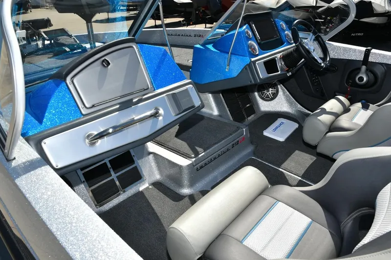 Slide: The Image of 2024 Ranger 212LS Reata boat interior with modern dashboard and seating. - 5