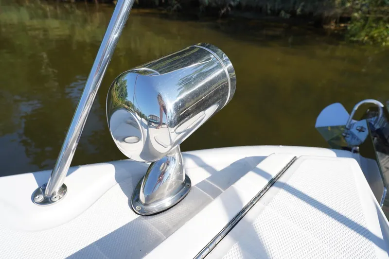 Slide: The Image of Chrome spotlight on 2010 Sea Ray 370 Sundancer boat deck by water. - 14