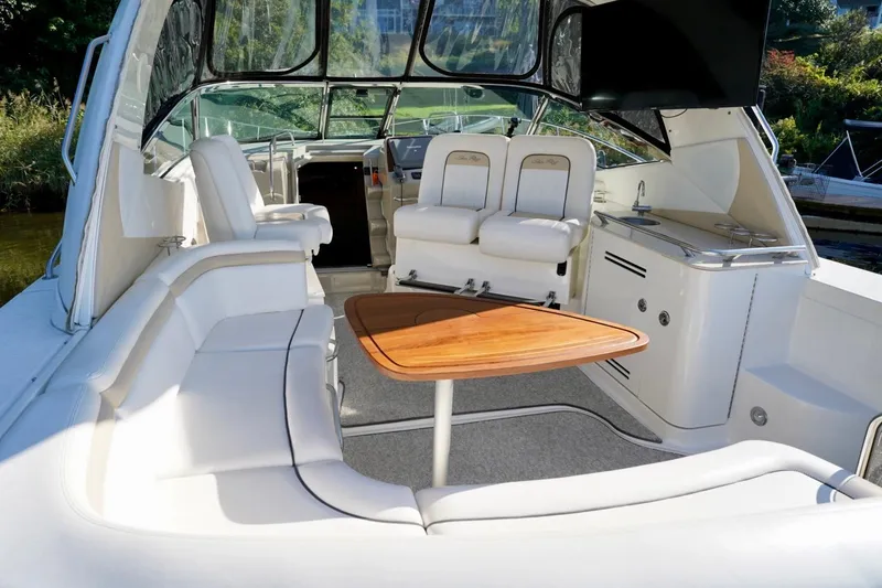Slide: The Image of Luxurious 2010 Sea Ray 370 Sundancer yacht interior with white seating and wooden table. - 22