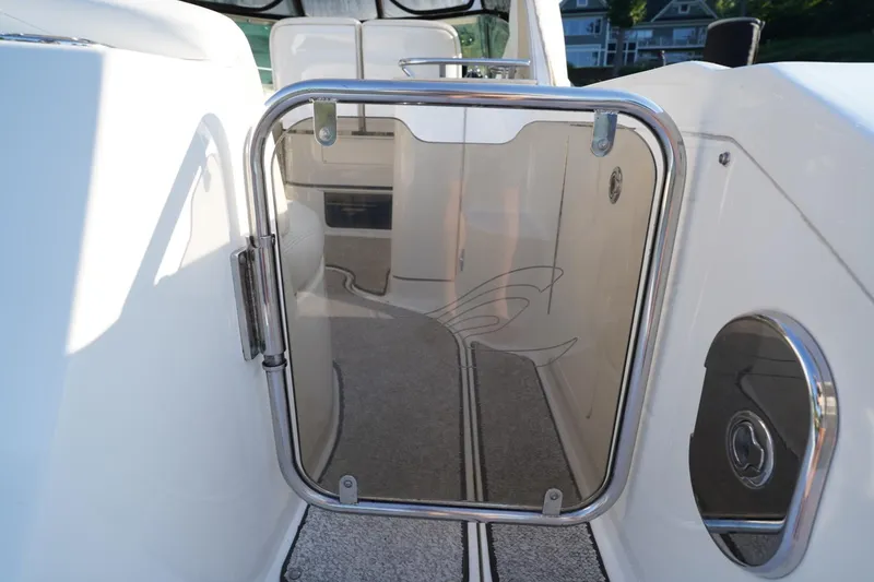 Slide: The Image of 2010 Sea Ray 370 Sundancer boat interior with glass door and carpeted flooring. - 26