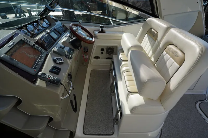 Slide: The Image of Helm of 2010 Sea Ray 370 Sundancer with dual seats and navigation controls. - 35