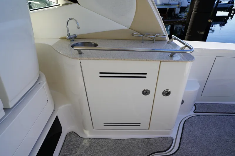 Slide: The Image of 2010 Sea Ray 370 Sundancer yacht kitchenette with sink and storage cabinets. - 37