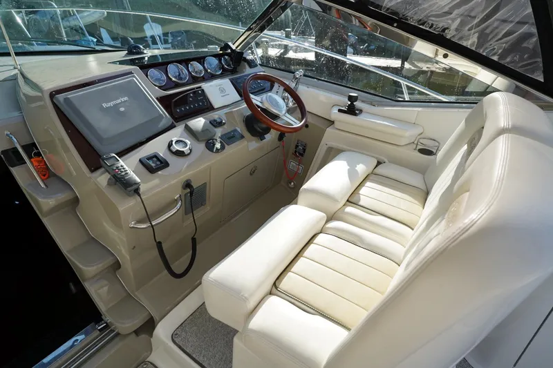 Slide: The Image of Cockpit of 2010 Sea Ray 370 Sundancer with steering wheel and navigation equipment. - 41
