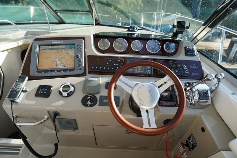 Slide: The Image of Cockpit of 2010 Sea Ray 370 Sundancer with navigation system and controls. - 42