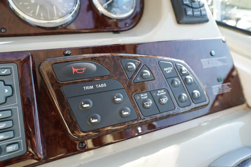 Slide: The Image of Control panel of a 2010 Sea Ray 370 Sundancer boat with various switches. - 46