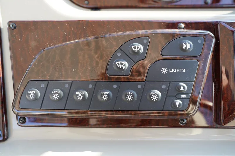 Slide: The Image of Control panel of a 2010 Sea Ray 370 Sundancer boat with various function buttons. - 47