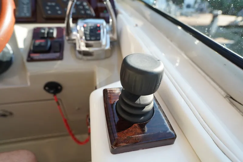 Slide: The Image of Control panel of a 2010 Sea Ray 370 Sundancer boat, featuring joystick and throttle. - 49