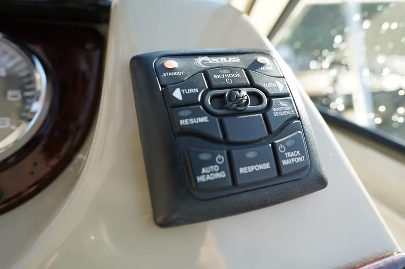 Slide: The Image of Control panel of a 2010 Sea Ray 370 Sundancer boat, featuring Axius joystick. - 50