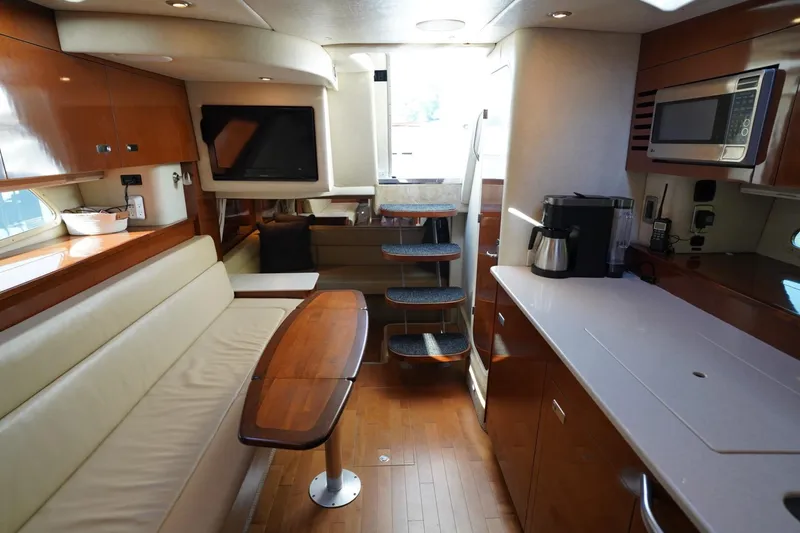 Slide: The Image of Luxurious interior of 2010 Sea Ray 370 Sundancer yacht with modern kitchen and seating area. - 53