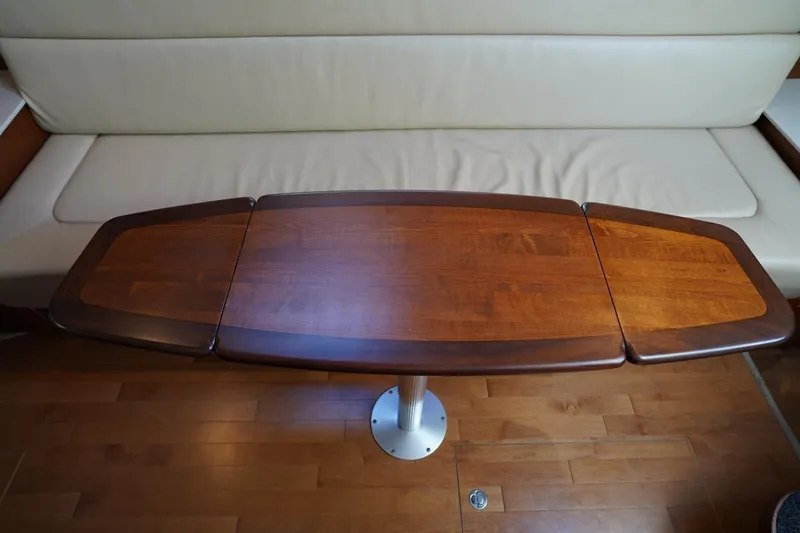 Slide: The Image of Wooden table in 2010 Sea Ray 370 Sundancer yacht interior, with beige seating. - 56