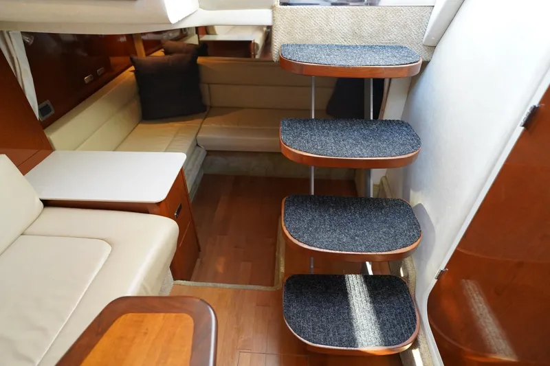Slide: The Image of Interior of 2010 Sea Ray 370 Sundancer yacht with carpeted stairs and seating area. - 57