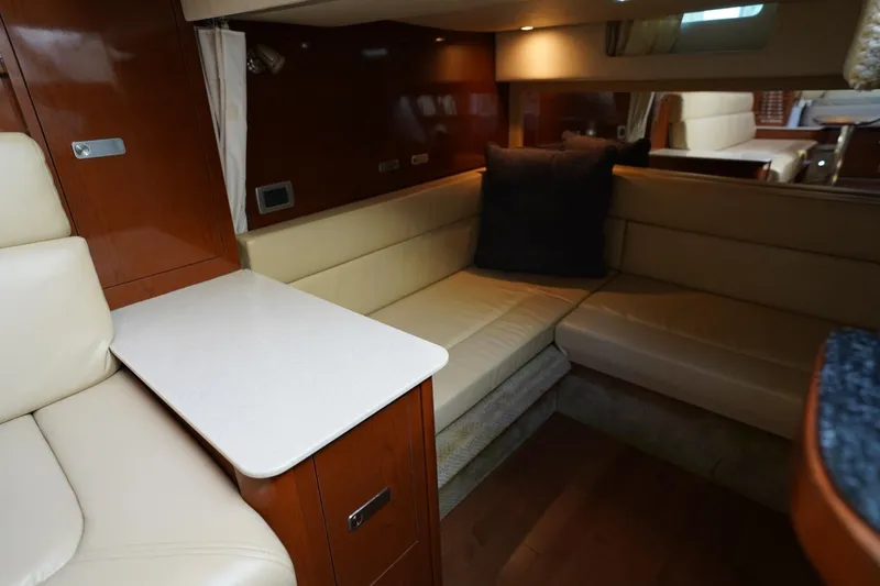 Slide: The Image of Luxurious interior of 2010 Sea Ray 370 Sundancer yacht with beige seating and wooden accents. - 58