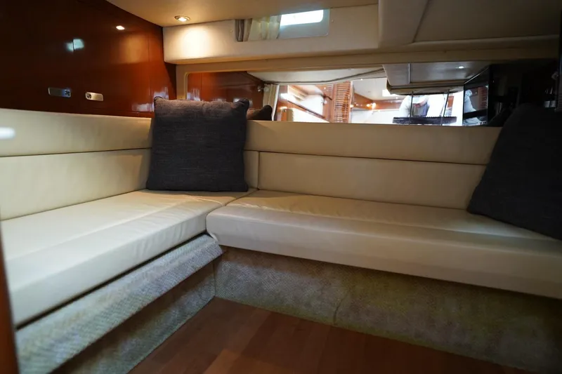 Slide: The Image of Luxurious interior of 2010 Sea Ray 370 Sundancer yacht with beige seating and cushions. - 59