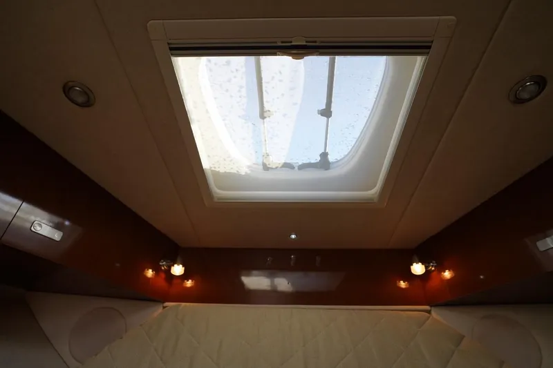 Slide: The Image of Interior view of 2010 Sea Ray 370 Sundancer cabin with skylight and ambient lighting. - 62