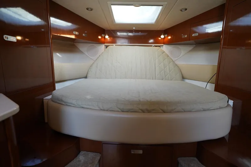 Slide: The Image of Luxurious cabin interior of 2010 Sea Ray 370 Sundancer with cozy bed and wooden finish. - 63