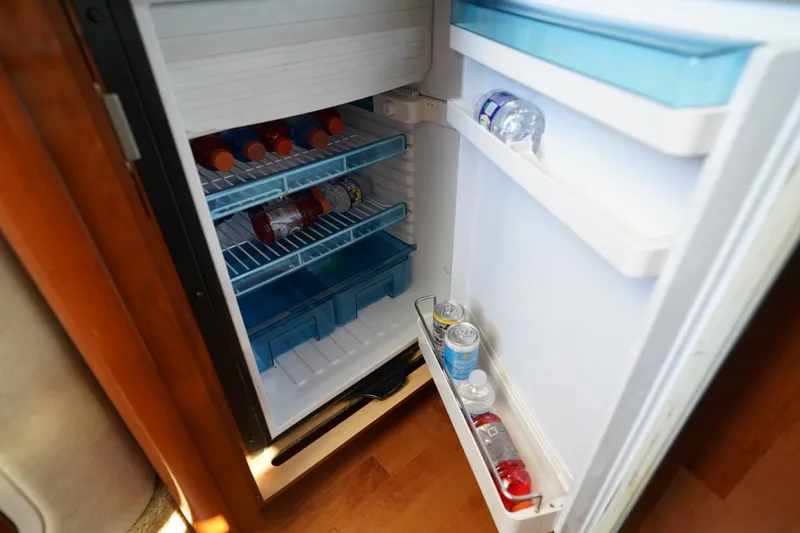 Slide: The Image of Open fridge on 2010 Sea Ray 370 Sundancer yacht, stocked with drinks and beverages. - 67