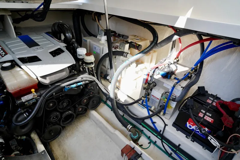 Slide: The Image of Engine compartment of a 2010 Sea Ray 370 Sundancer with visible wiring and components. - 74