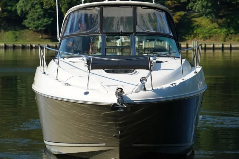 Slide: The Image of 2010 Sea Ray 370 Sundancer yacht on calm water, front view. - 9