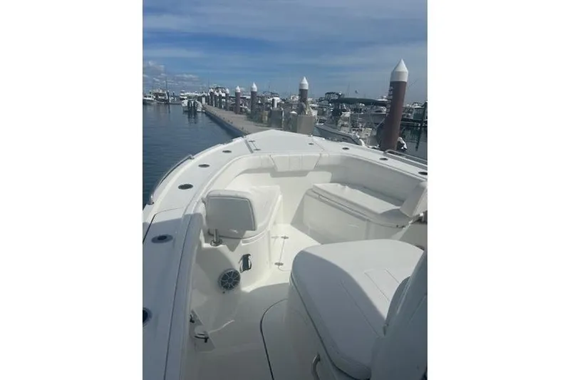 Slide: The Image of 2025 Parker 2600 Center Console boat docked at marina under clear skies. - 10
