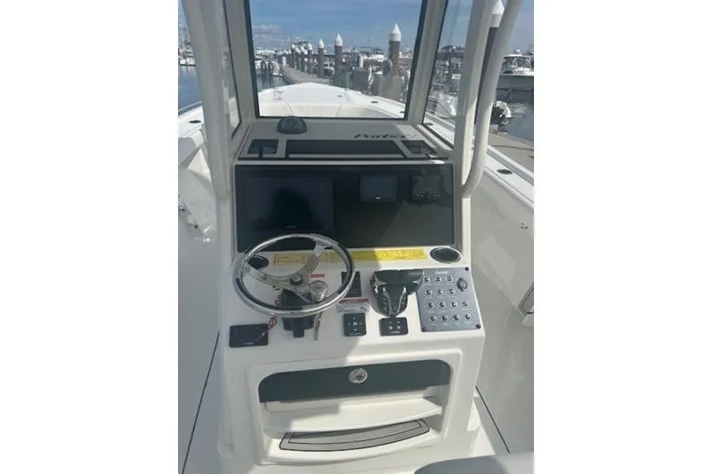 Slide: The Image of 2025 Parker 2600 Center Console boat dashboard with steering wheel and controls. - 14