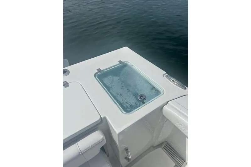 Slide: The Image of 2025 Parker 2600 Center Console boat with livewell on deck, floating on water. - 15