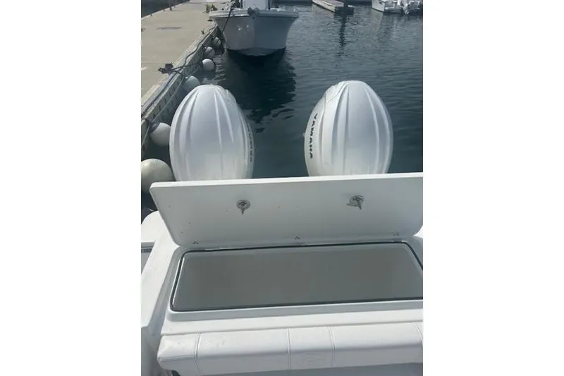 Slide: The Image of 2025 Parker 2600 Center Console boat with twin outboard engines at dock. - 17