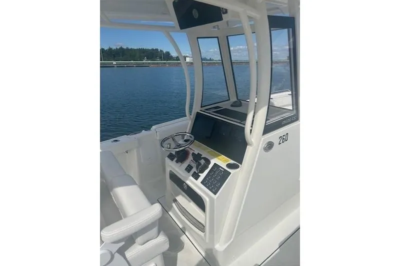 Slide: The Image of 2025 Parker 2600 Center Console boat interior with steering wheel and control panel. - 18