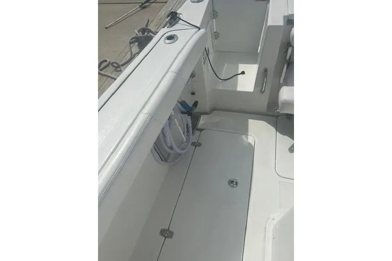 Slide: The Image of 2025 Parker 2600 Center Console boat interior, featuring storage compartments and clean deck design. - 3