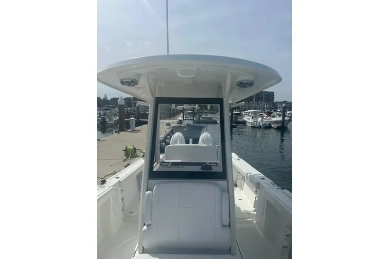 Slide: The Image of 2025 Parker 2600 Center Console boat docked at marina, showcasing sleek design and spacious layout. - 4