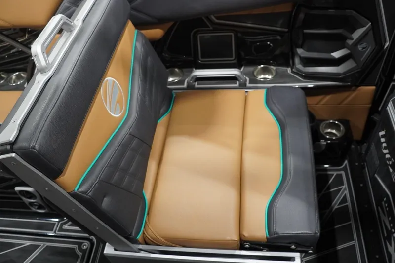 Slide: The Image of 2024 Tigé Ultré 25ZX boat interior with tan and black seating, teal accents. - 101
