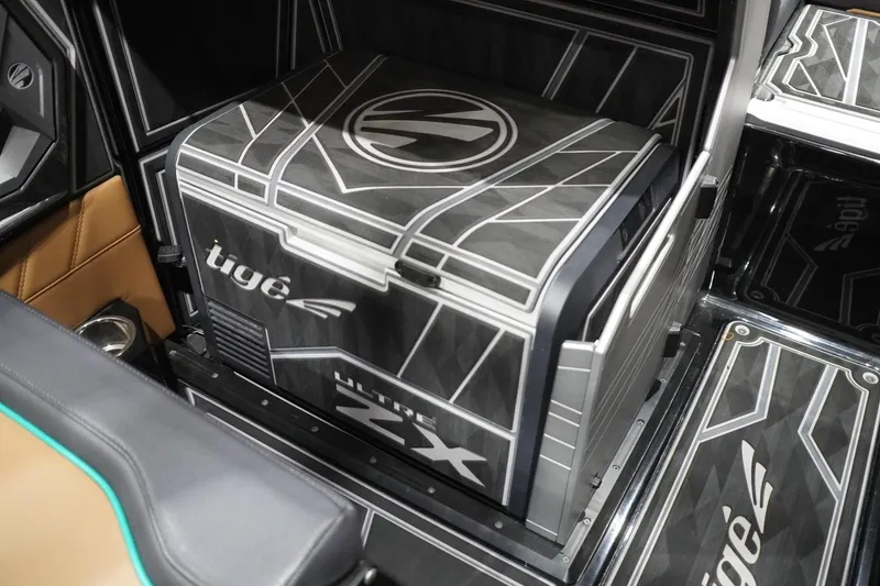 Slide: The Image of 2024 Tigé Ultré 25ZX interior featuring a stylish, modern cooler design. - 102