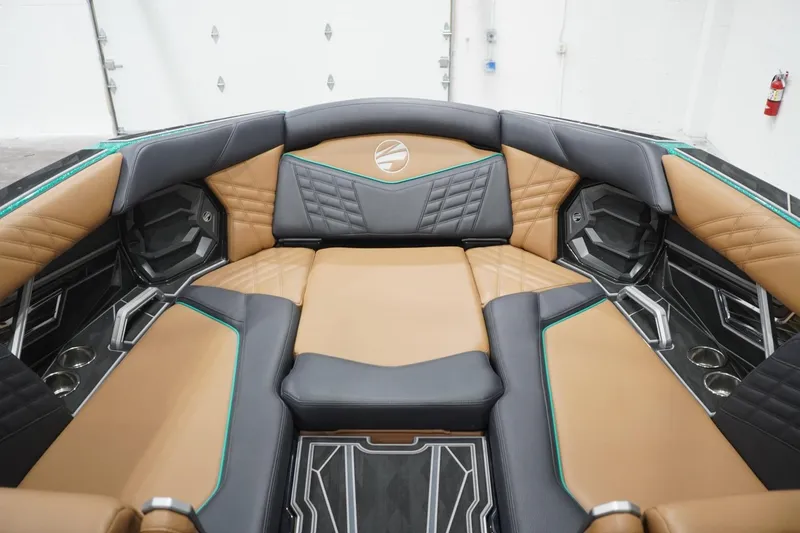Slide: The Image of Luxurious interior of 2024 Tigé Ultré 25ZX boat with tan and black seating. - 103