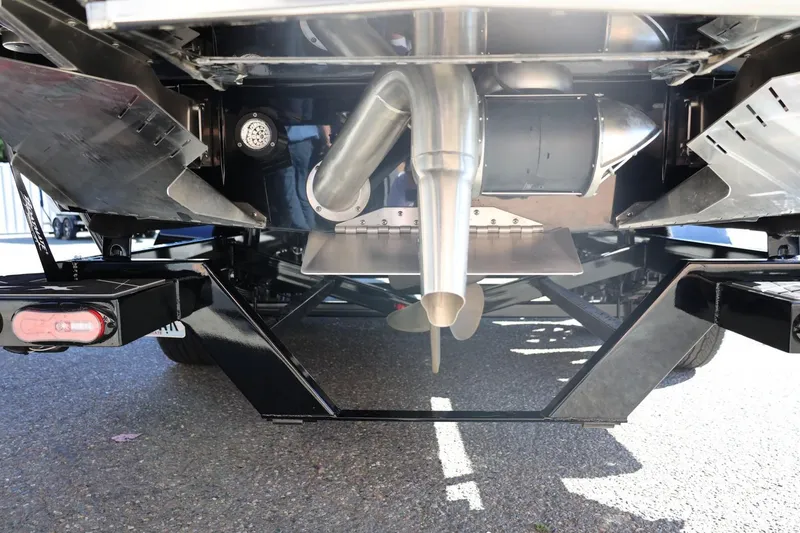 Slide: The Image of 2024 Tigé Ultré 25ZX boat underside showing propeller and exhaust system. - 13