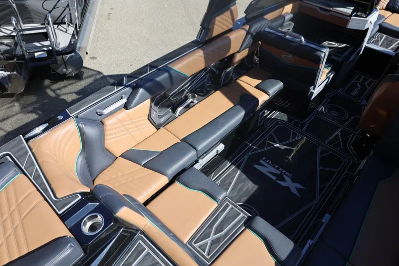 Slide: The Image of 2024 Tigé Ultré 25ZX boat interior with luxurious seating and modern design. - 18