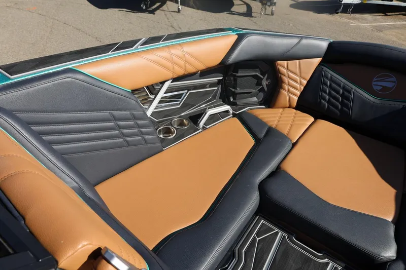 Slide: The Image of 2024 Tigé Ultré 25ZX boat interior with tan and black leather seating. - 22