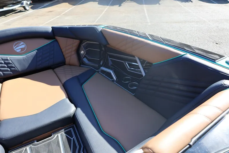 Slide: The Image of 2024 Tigé Ultré 25ZX boat interior with luxurious brown and black seating. - 23