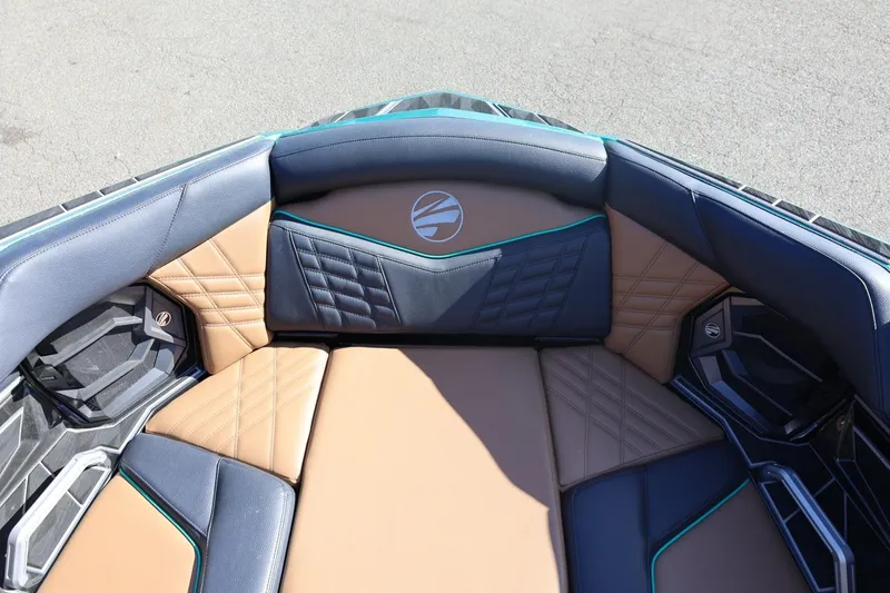 Slide: The Image of 2024 Tigé Ultré 25ZX boat interior with luxurious tan and black seating. - 24